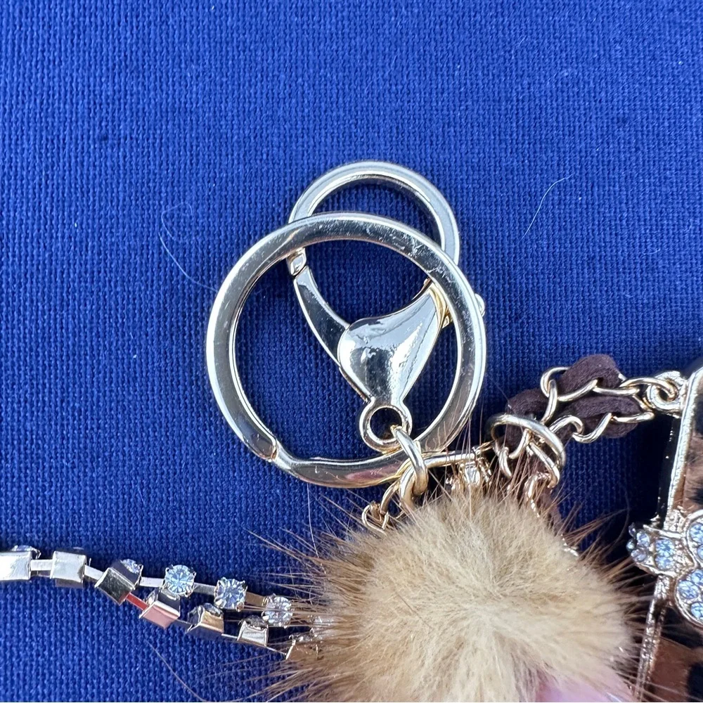 Unbranded keychain or purse charm. White, tan and black. NEW